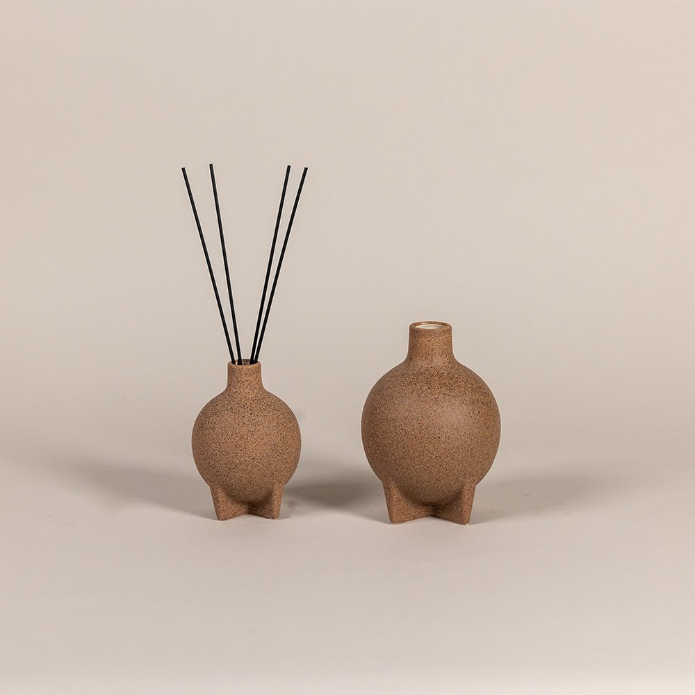 Reed diffusers with stone-inspired decorative vessel