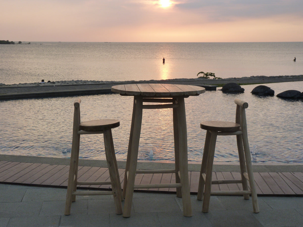 Wilma Outdoor Bar Set beside a pool at dusk, front view
