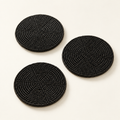 Black beaded coaster set, top catalog view on warm ivory