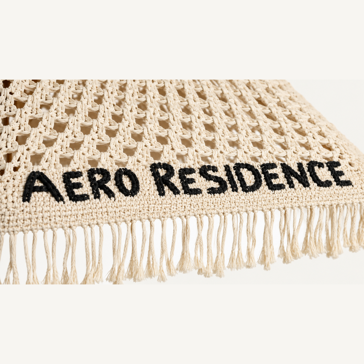 Close detail of natural hand-crocheted custom lettering in macrame