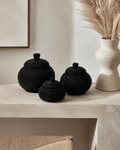 Black hand-beaded lidded baskets in a luxury Miami interior