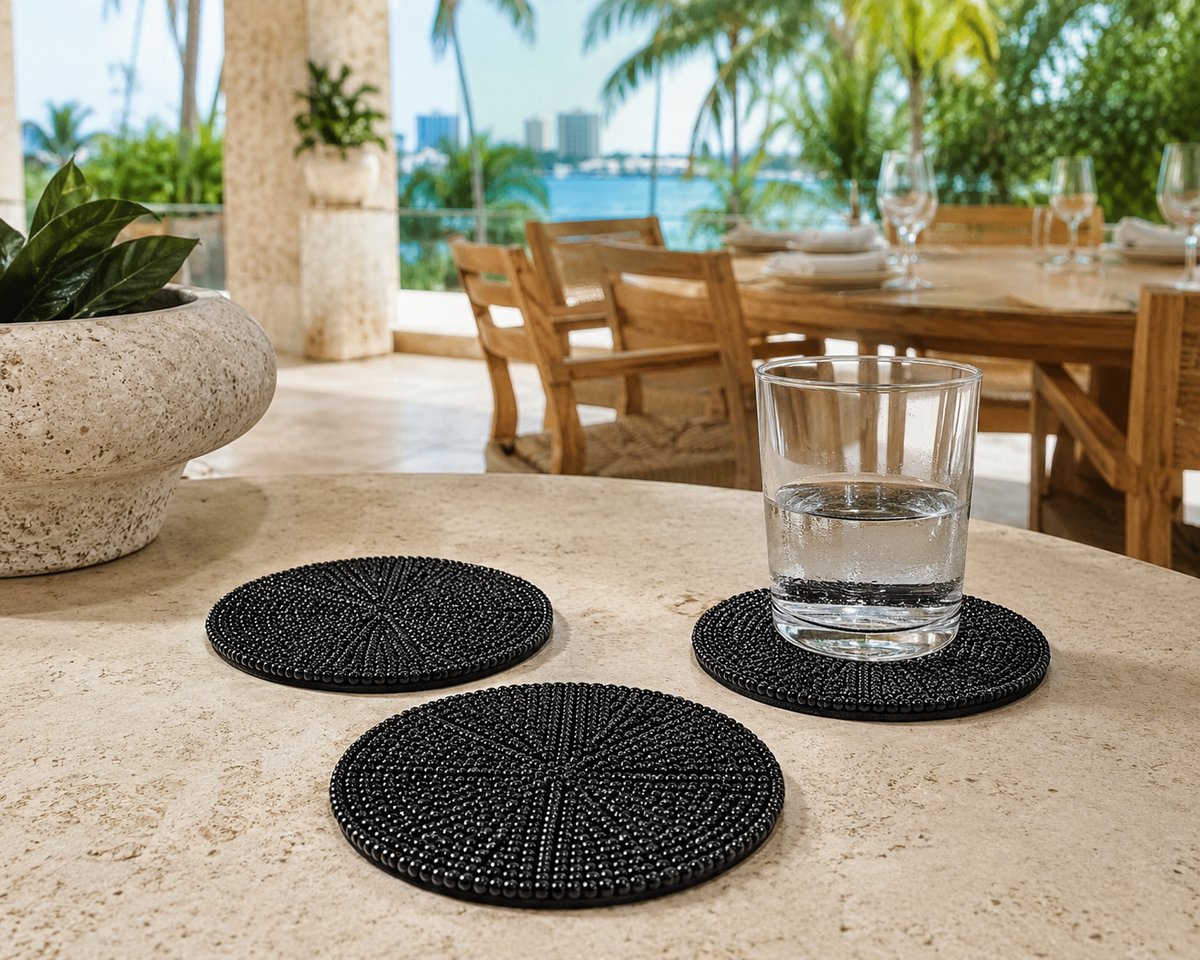 Black hand-beaded coaster in a covered Miami dining terrace