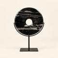 Black natural stone disk on metal stand, front view