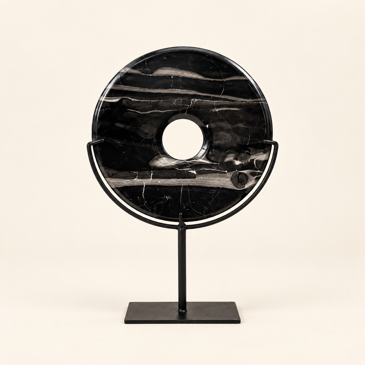 Black natural stone disk on metal stand, front view