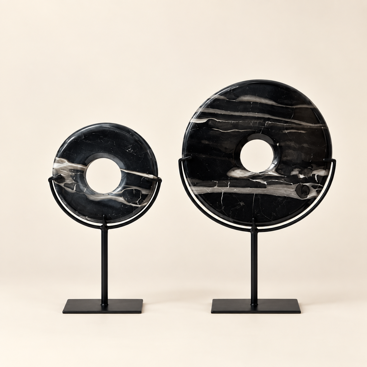 Black natural stone disks in two sizes on metal stands
