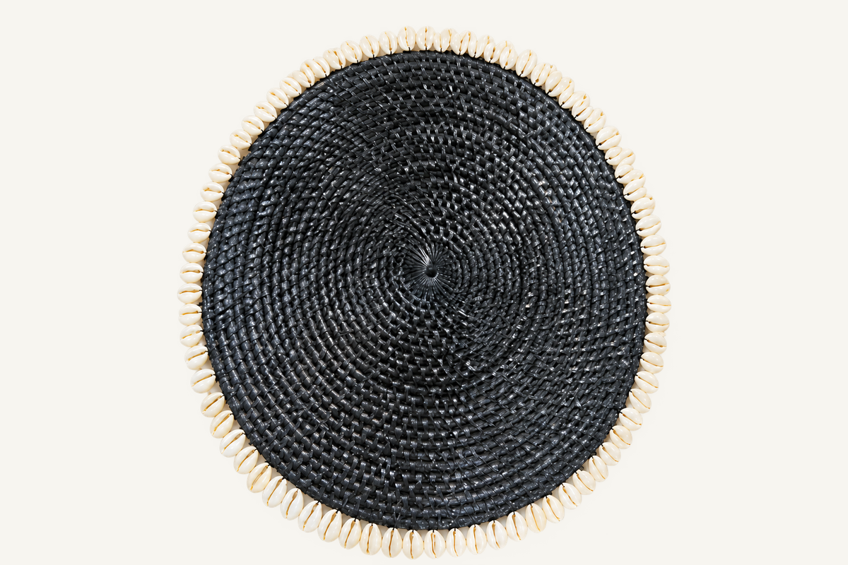 Handwoven Rattan & Cowrie Shell Coaster in Black, angled view
