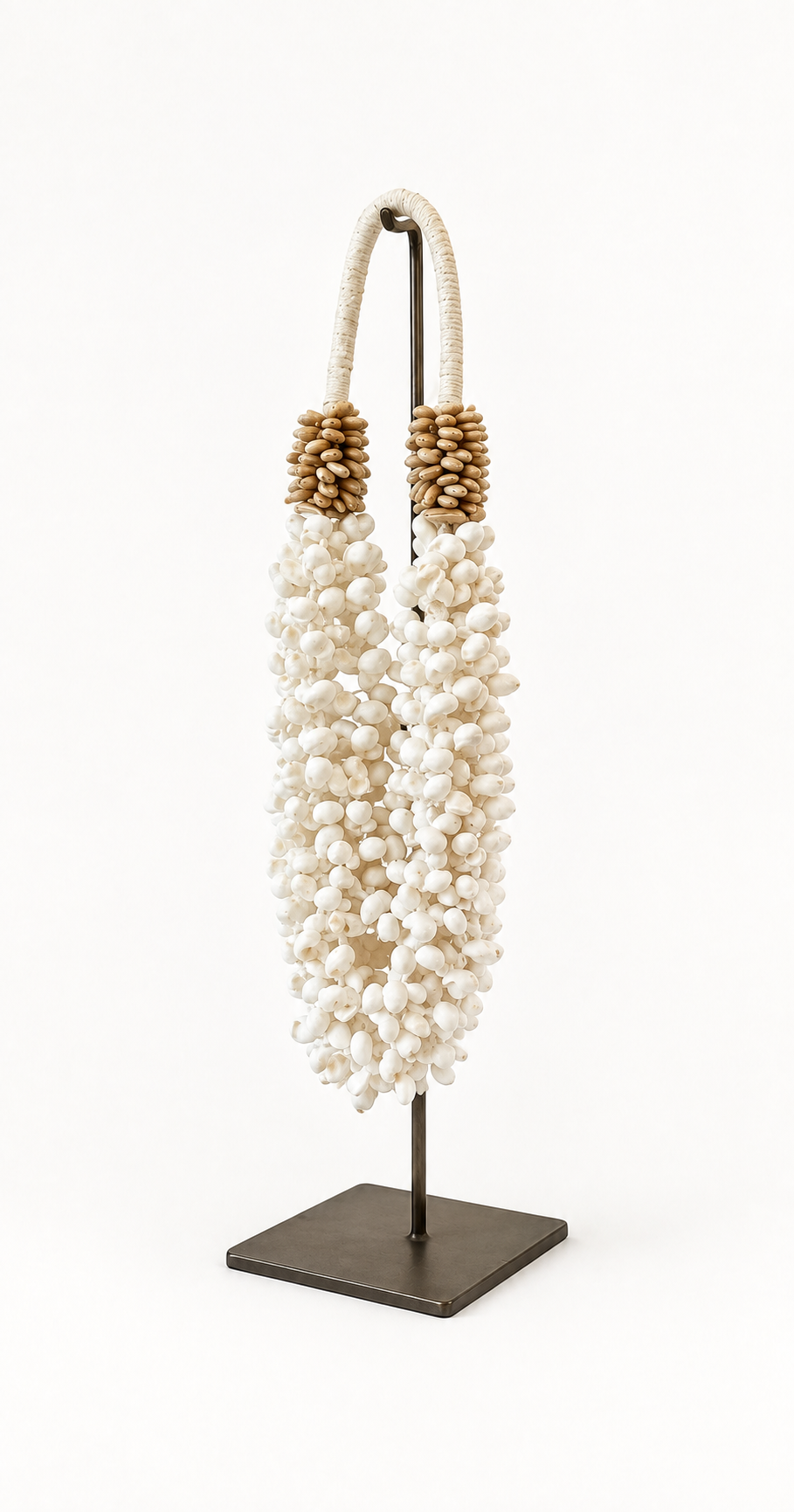 Buteng decorative shell necklace — Buteng shell necklace on metal stand, three-quarter catalog view