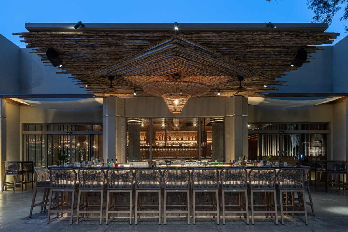 Custom wood ceiling, woven pendant and bar furniture by Cabana