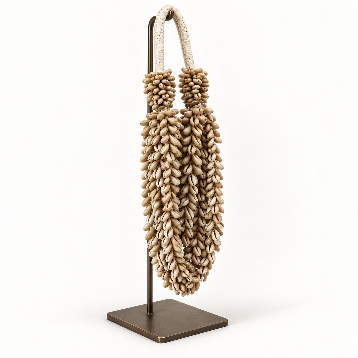 Cowrie decorative shell necklace — Cowrie shell necklace on metal stand, side detail view
