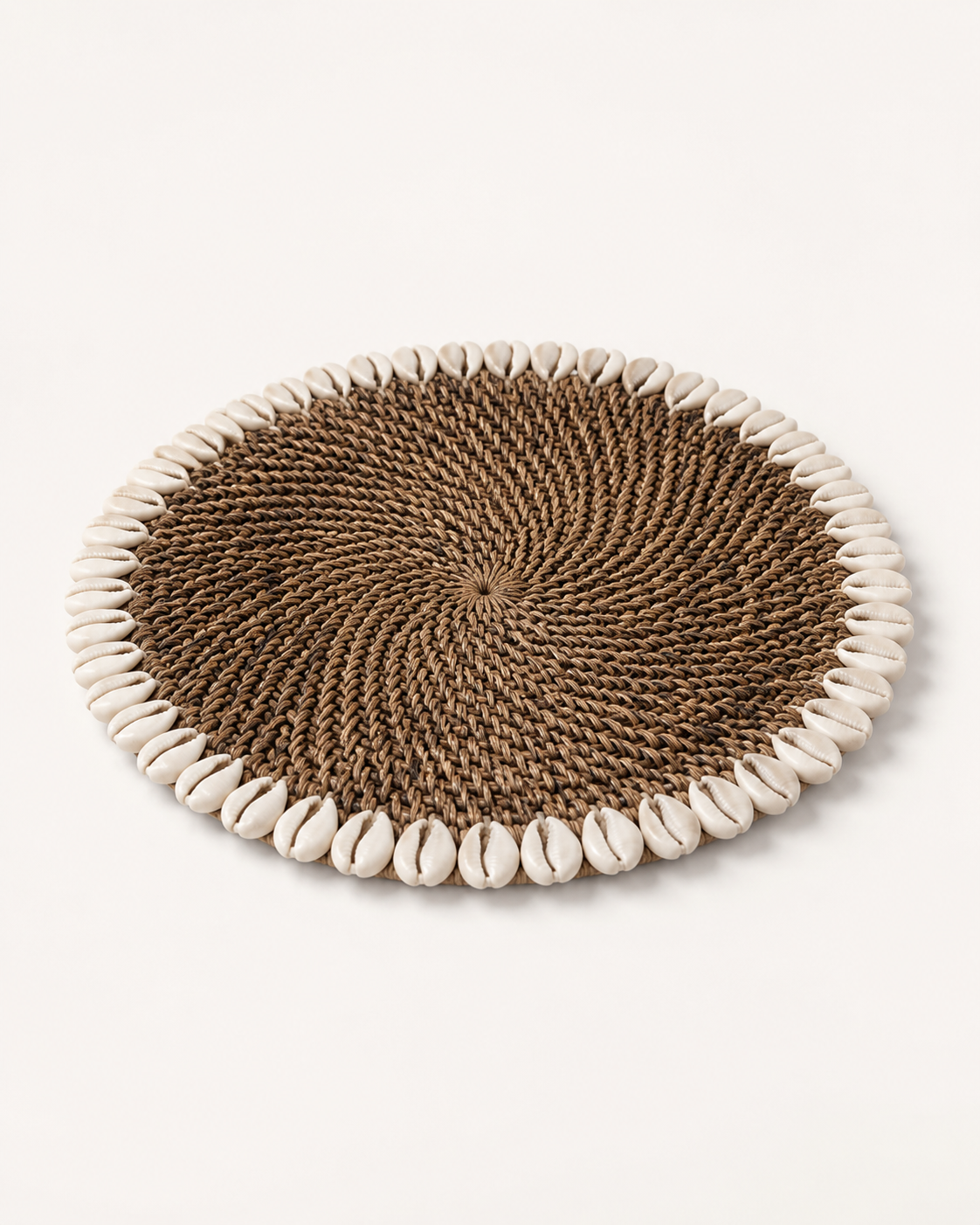 Handwoven Rattan & Cowrie Shell Coaster in Dark Natural, angled view