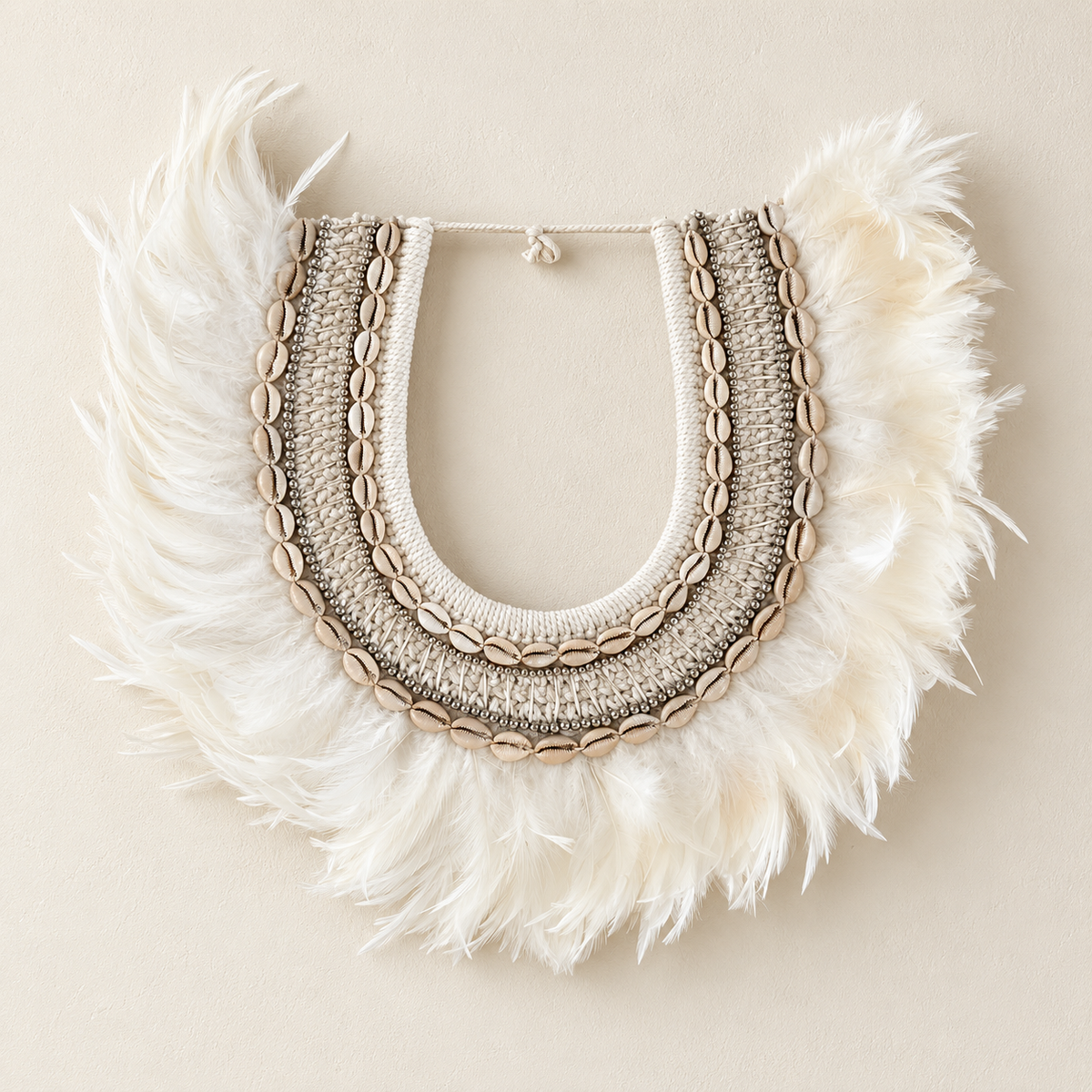 Feathered Shell decorative shell necklace — Feathered Shell Necklace displayed directly on a clean warm cream wall