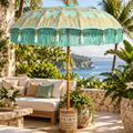 Traditional Balinese teak umbrella in turquoise and gold on a tropical terrace