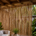Premium teak branches used as a natural privacy screen in a luxury tropical patio
