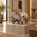 Recycled metal barrel Triceratops sculpture in a gallery interior