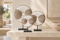 White Geometric shell donut sculptures styled on a console