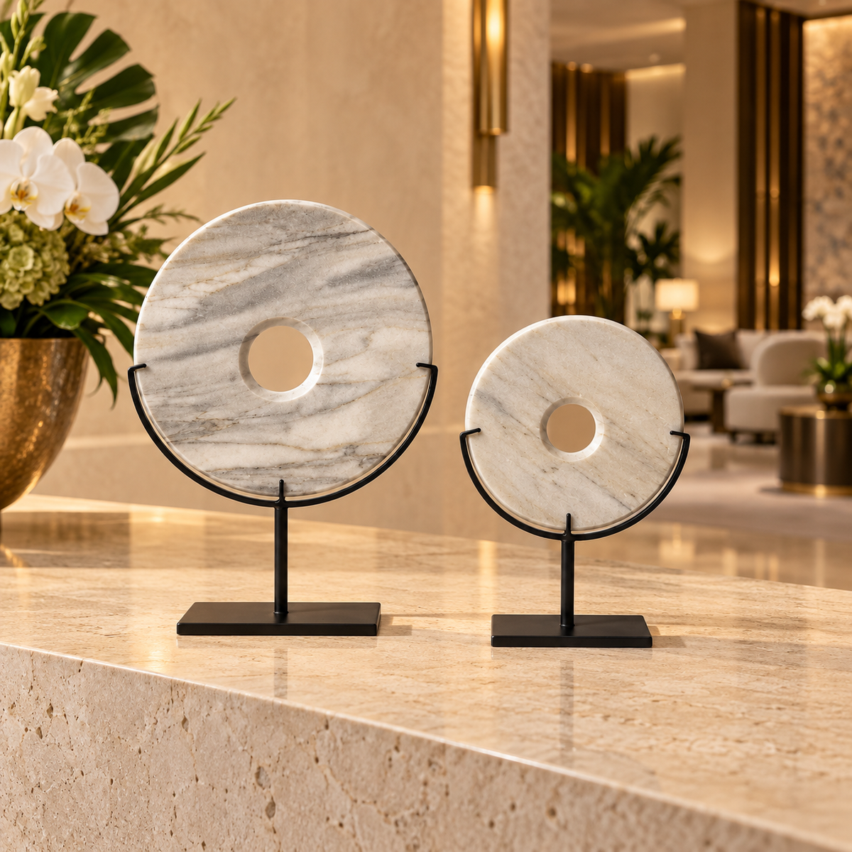 Two white natural stone disk sculptures in a luxury Miami hotel lobby