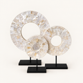 Three White Shell Disk sculptures on included black metal stands
