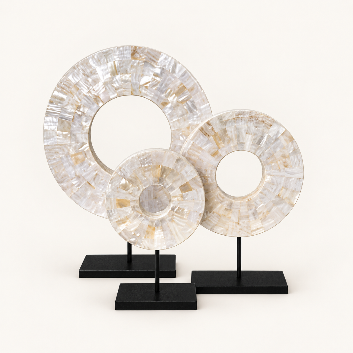 Three White Shell Disk sculptures on included black metal stands
